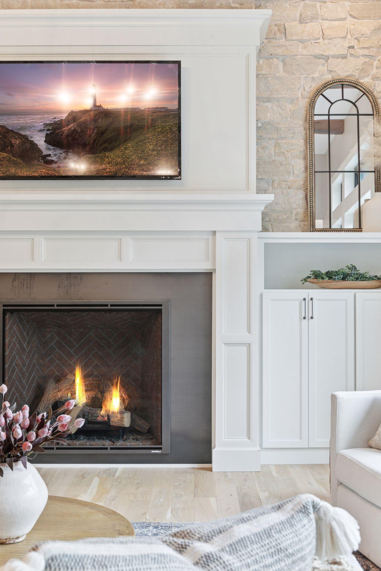 Close-up of the fireplace showcasing intricate trimwork, rich stone backdrop, and warm tones — the perfect blend of comfort and design.