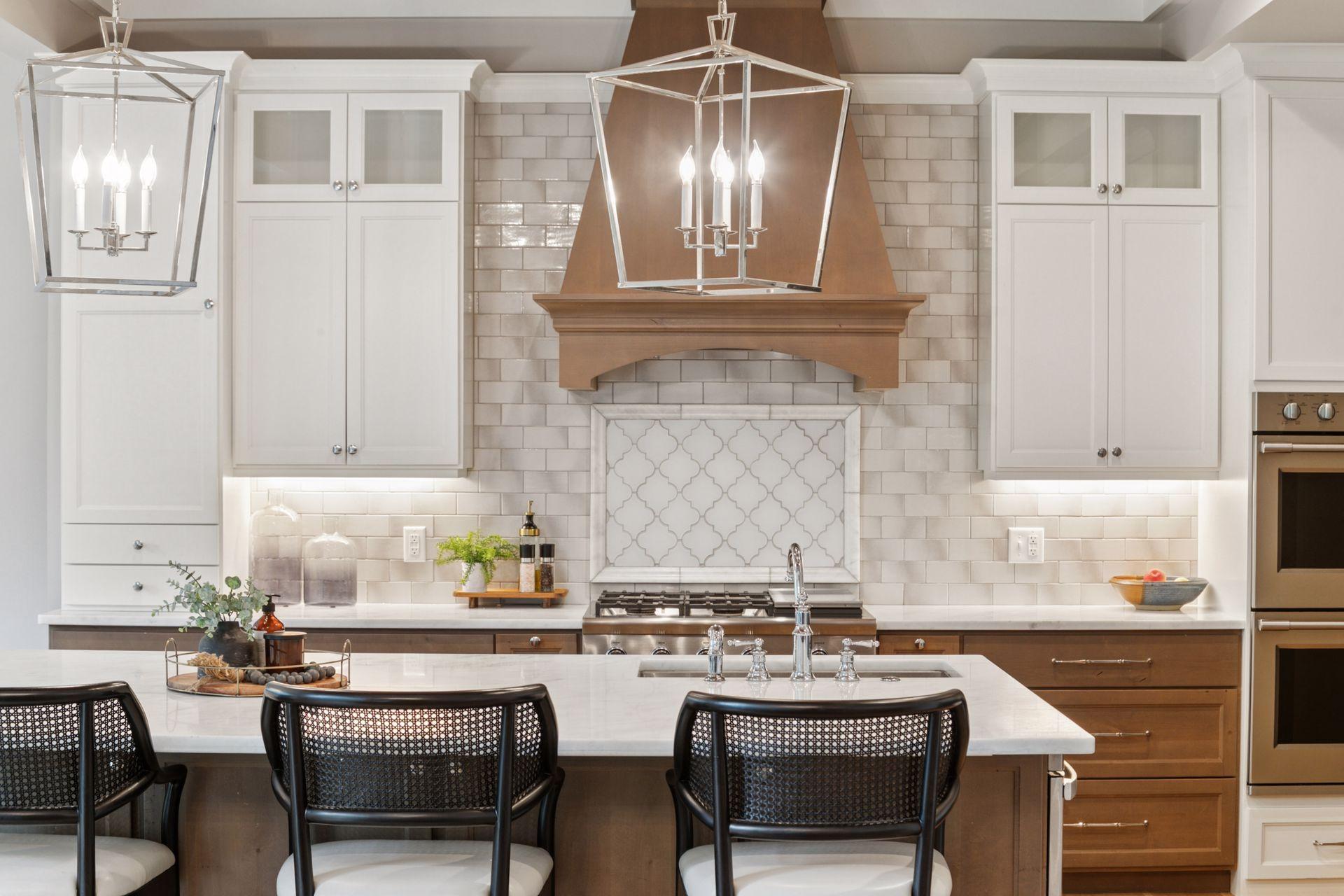 Custom cabinetry and custom range hood anchor this chef’s kitchen, with built-in wall ovens and detailed millwork throughout.