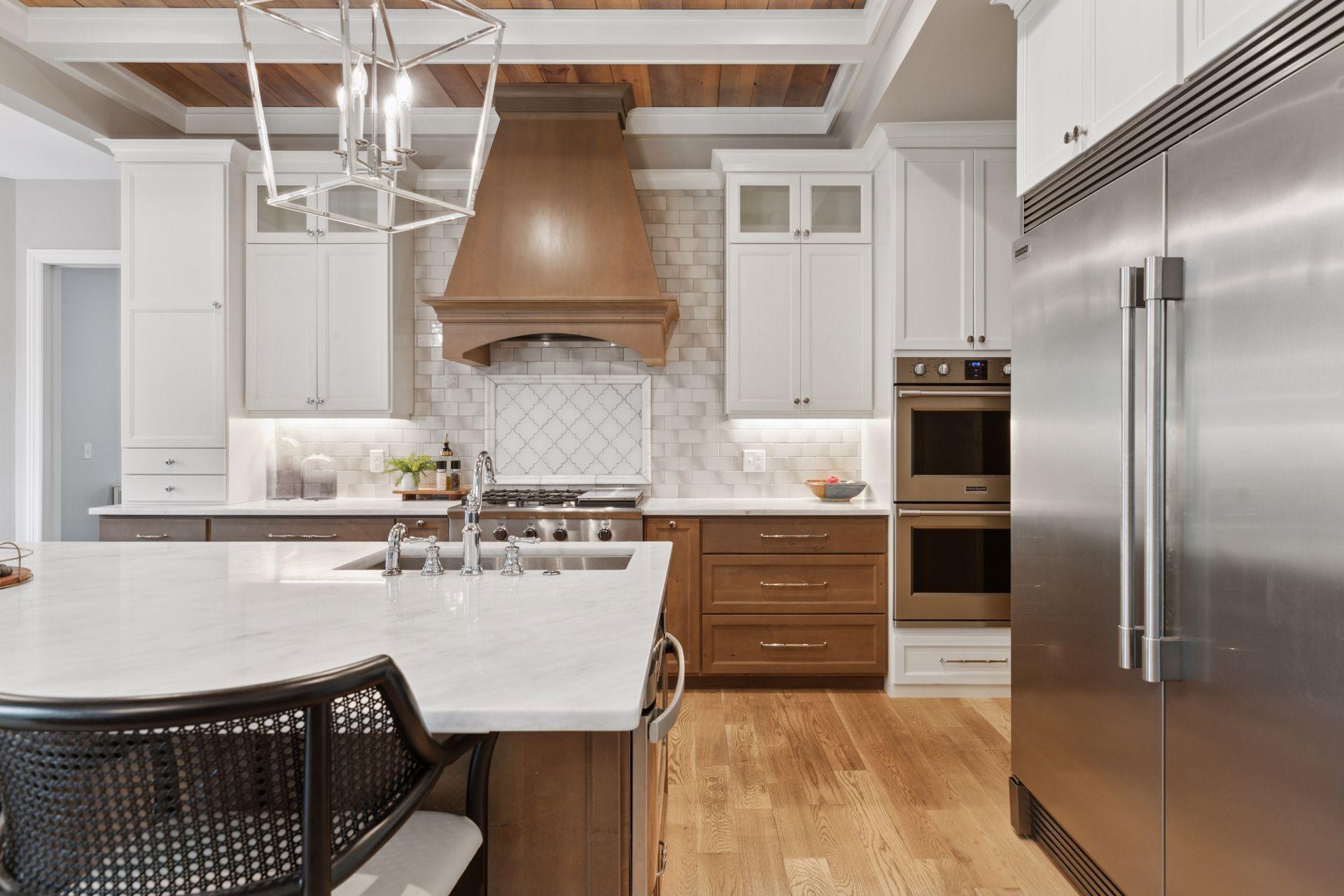 Premium kitchen finishes include built-in double ovens and a paneled refrigerator wall, blending high performance with clean design.