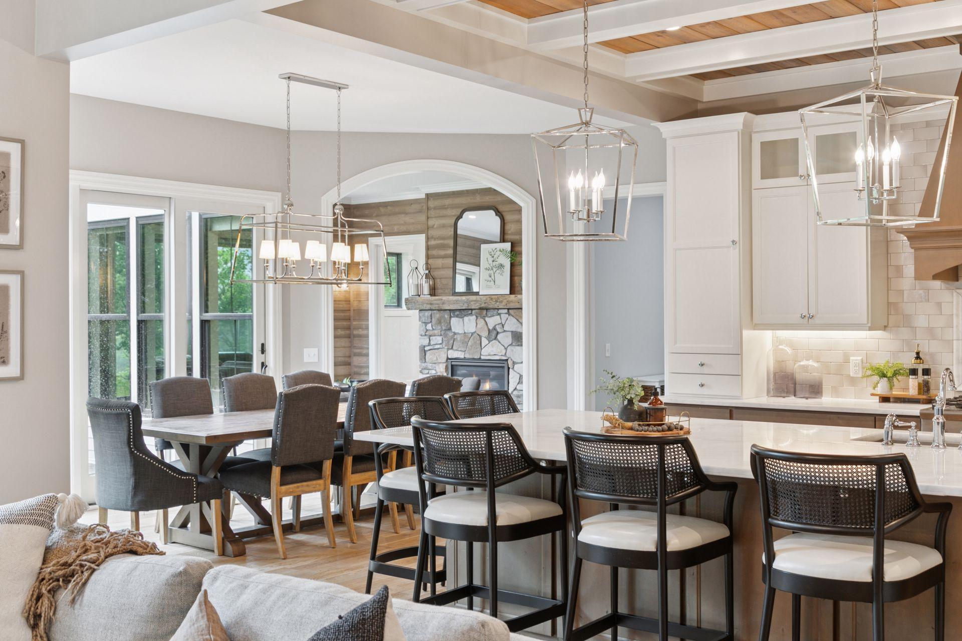Perfect for hosting, this layout connects the oversized island, great room, dining area, deck, and sunroom with stone fireplace in effortless style.