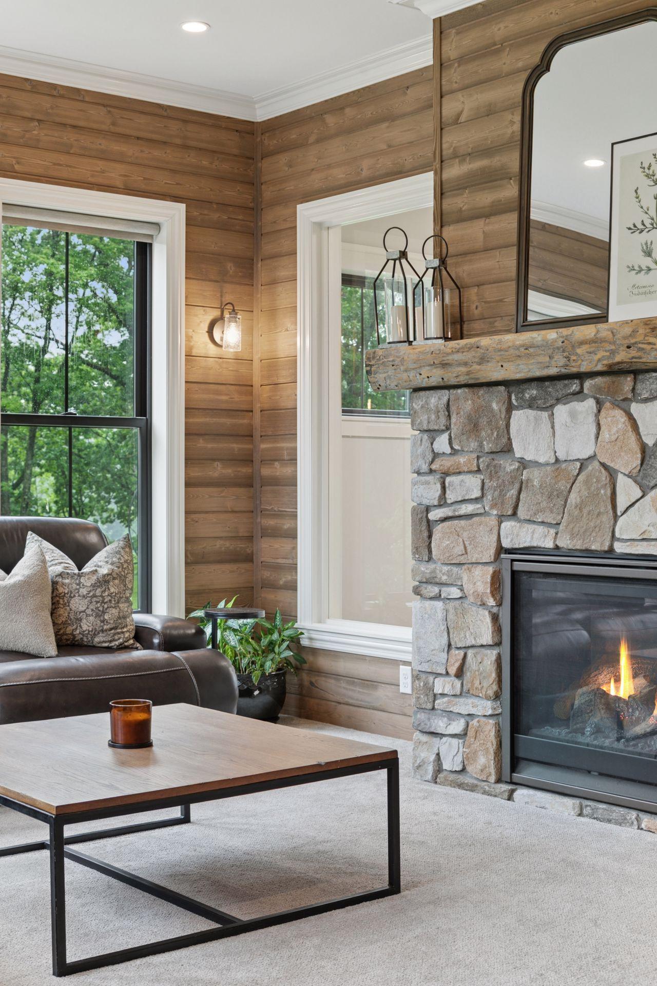 Close-up of the hearth room showcasing the rustic stone fireplace, custom mantel, and charming decor elements that bring warmth and character to the space.