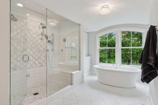 A closer view of the arched windows offers a lush, private backdrop that brings the outdoors into your luxurious bath retreat.