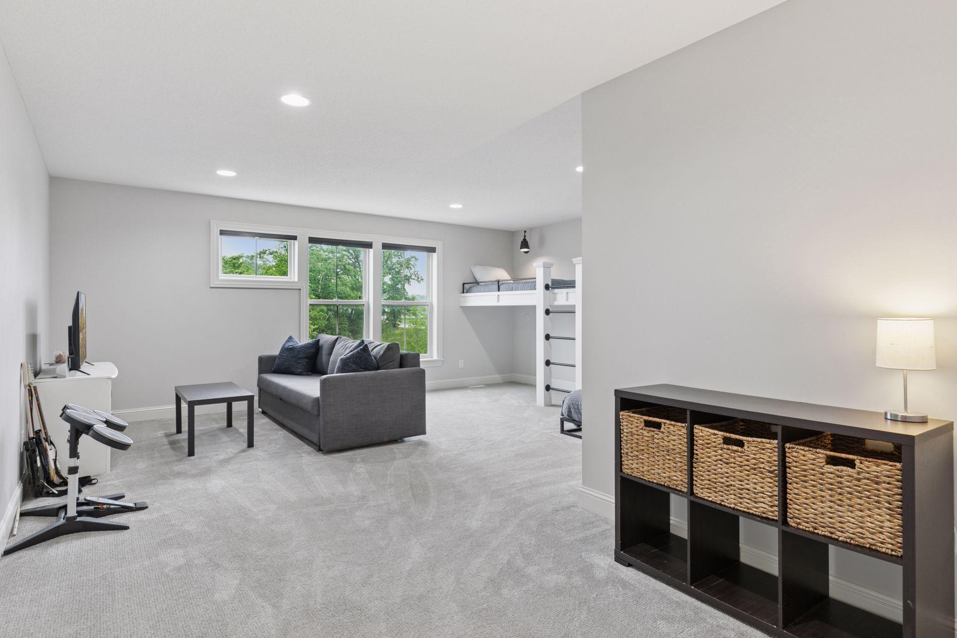 Spacious bonus room with large windows, recessed lighting, and built-in lofted bunk beds—perfect for lounging or play.