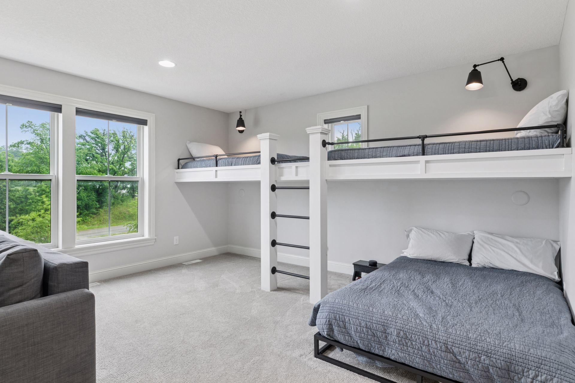 Custom-built bunk bed sleeping area with clean lines, integrated lighting, and cozy carpeting.