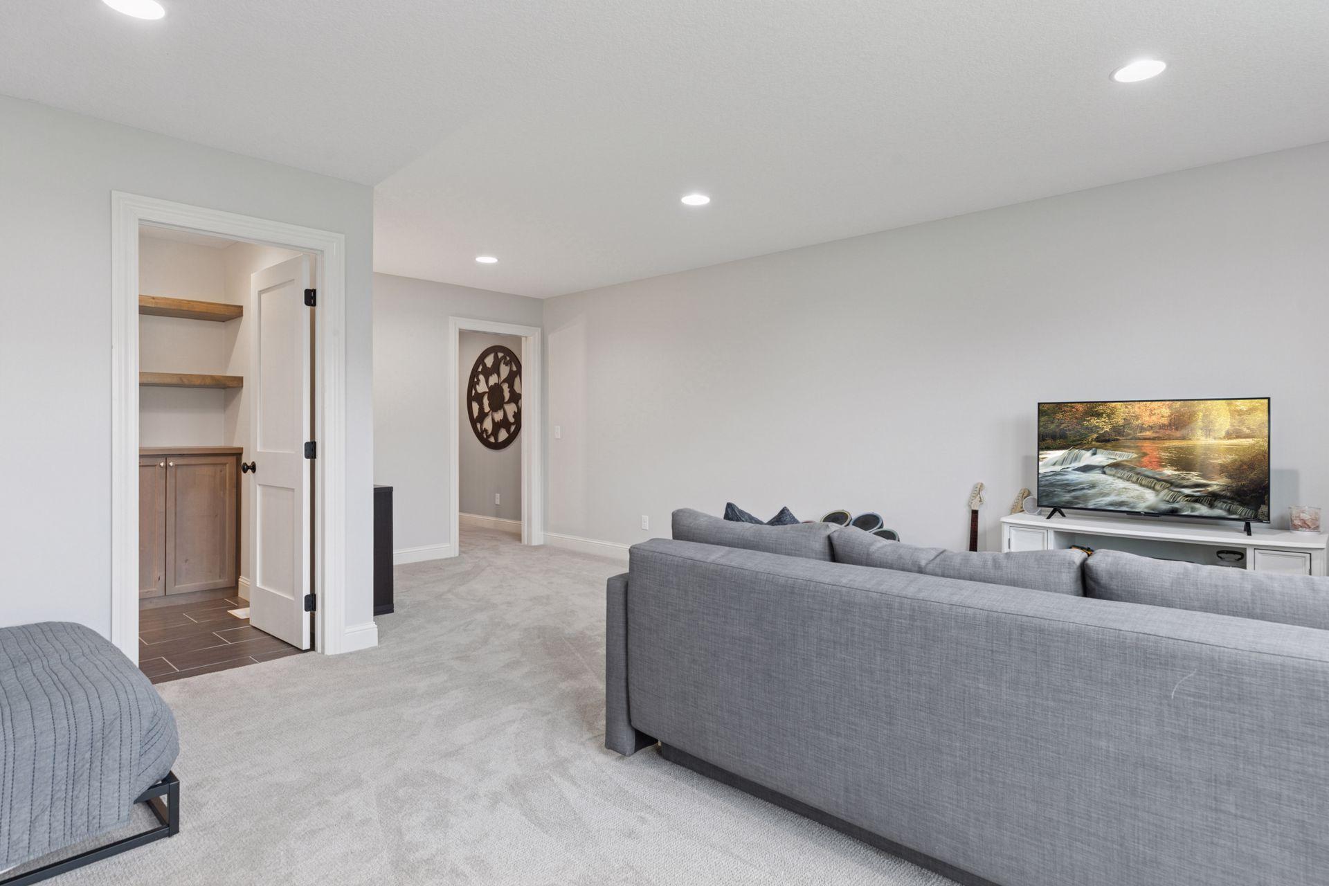 Open-concept upper living space with flexible seating area and access to additional storage.