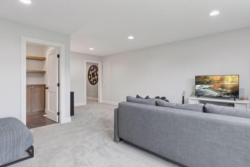 Open-concept upper living space with flexible seating area and access to additional storage.