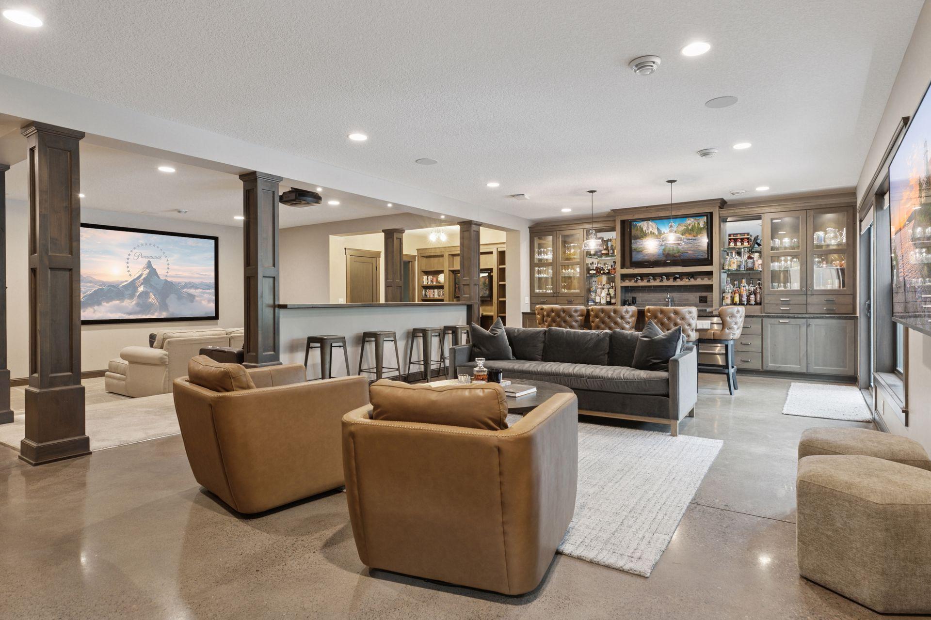 The lower-level living room blends laid-back comfort with refined design, offering an open layout, a stylish bar, and seamless flow to the home theater—perfect for entertaining and relaxing. The lower level features in-floor radiant heat.