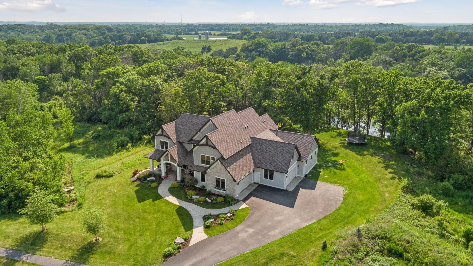 Aerial view showcases this private 3-acre estate surrounded by mature woods and rolling countryside—offering unmatched privacy, natural beauty, and space to roam.