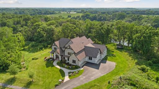 Aerial view showcases this private 3-acre estate surrounded by mature woods and rolling countrysideâoffering unmatched privacy, natural beauty, and space to roam.