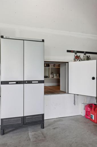 Handy garage access door to walk-in pantryâideal for seamless grocery drop-offs and smart storage solutions.