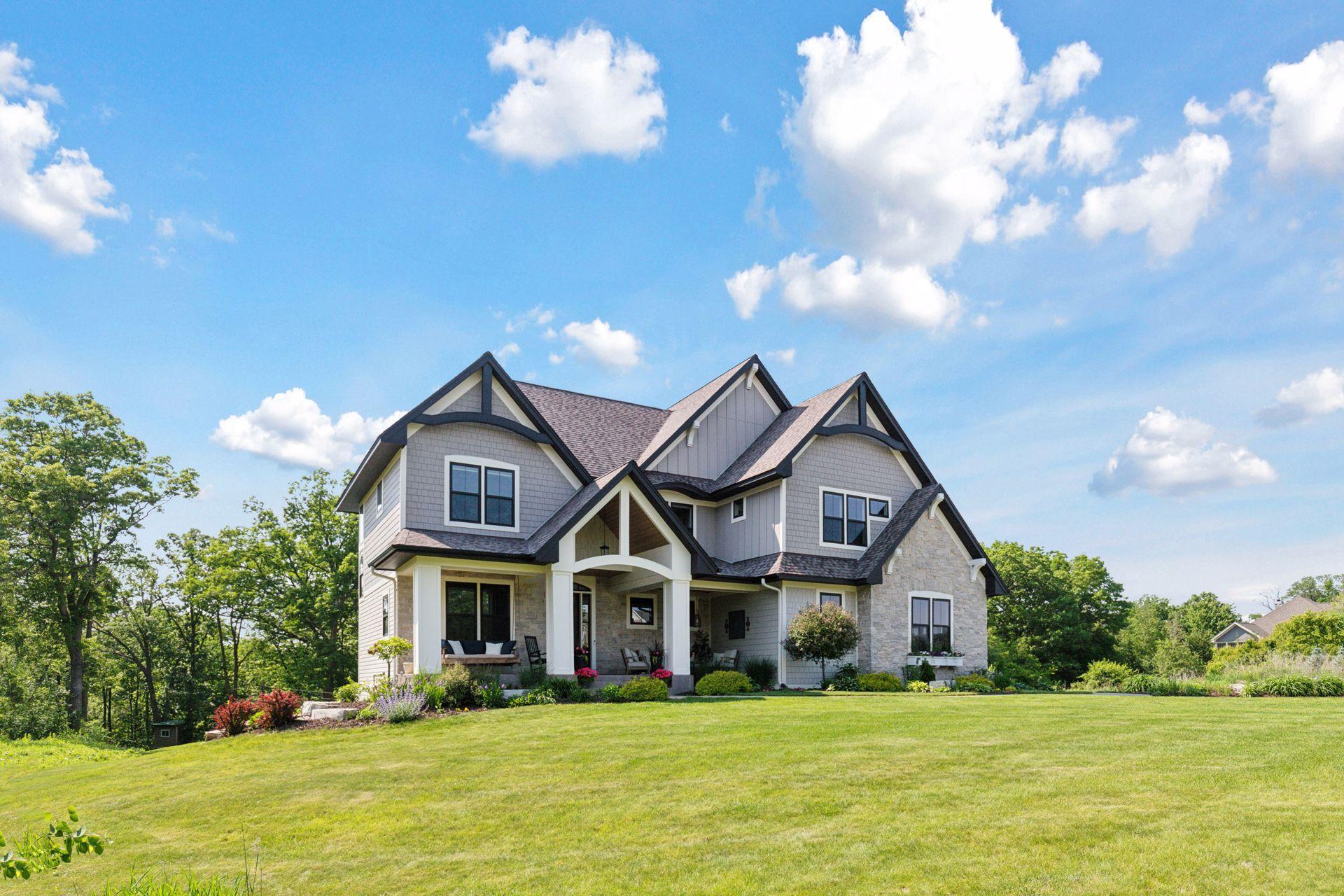Elegant corner angle of the home showcasing its architectural detail, manicured landscaping, and welcoming front porch.