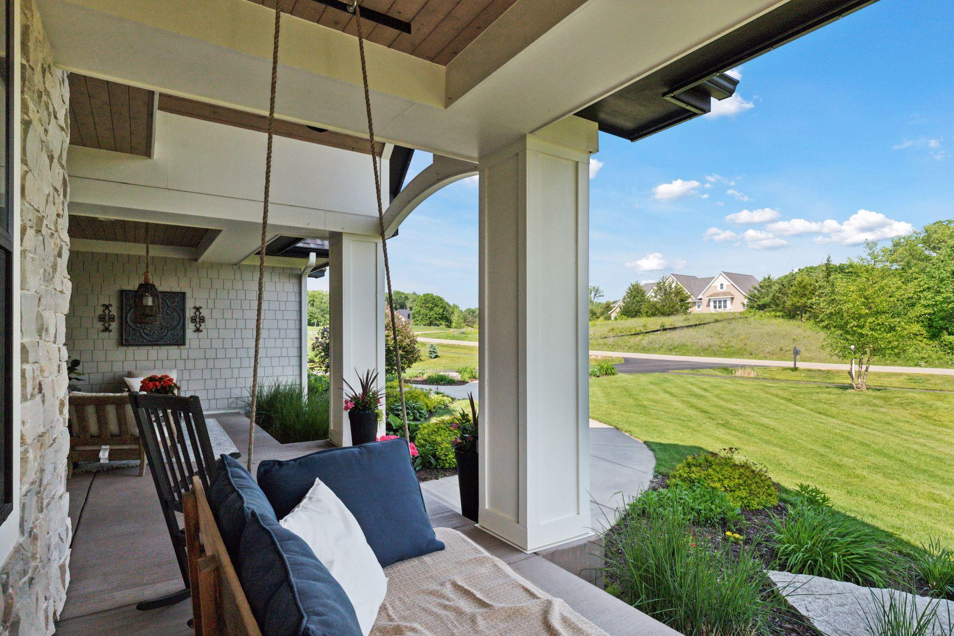 Relaxing covered front porch with porch swing and views of the peaceful cul-de-sac—perfect for morning coffee.