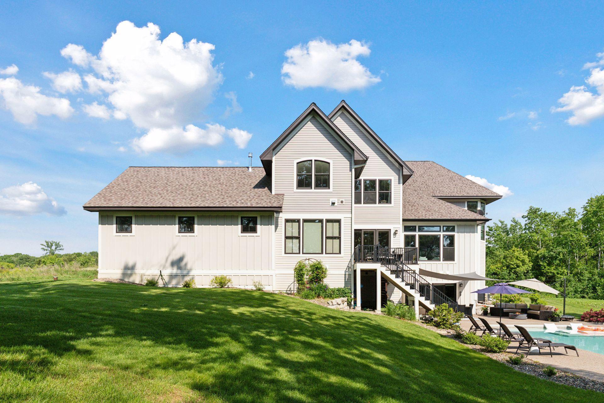 Stunning rear elevation showcases modern architecture and thoughtful design. Large windows flood the home with natural light, while the walkout access leads directly to your private backyard oasis.