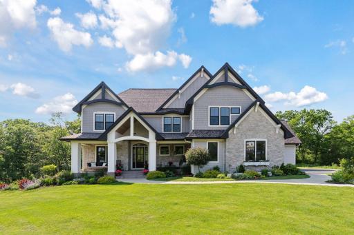 Welcome to 1432 25th Street in Houlton, Wisconsin. This stunning Craftsman-style home features stone accents, an expansive front porch, and a private setting on 3+ scenic acres in Houlton.
