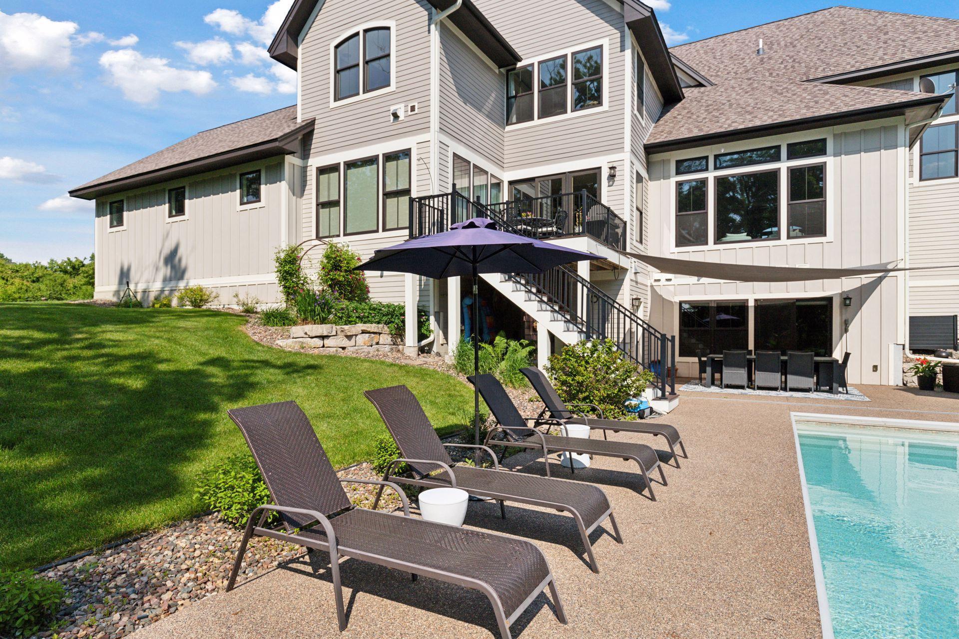 Soak up the sun in style. Relax in multiple lounge chairs under a shade umbrella, with a stairway leading up to the main-level deck overlooking the sparkling pool.