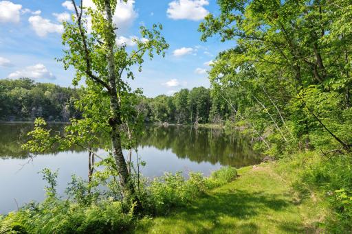Private walking trail leads to the water's edgeâsecluded, quiet, and surrounded by natural beauty. A perfect retreat within your own backyard.