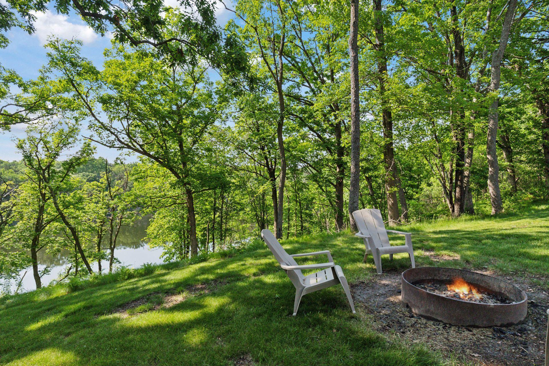Tranquil firepit circle perched near the bluff, offering a relaxing space with views of the surrounding woods and private water access below.