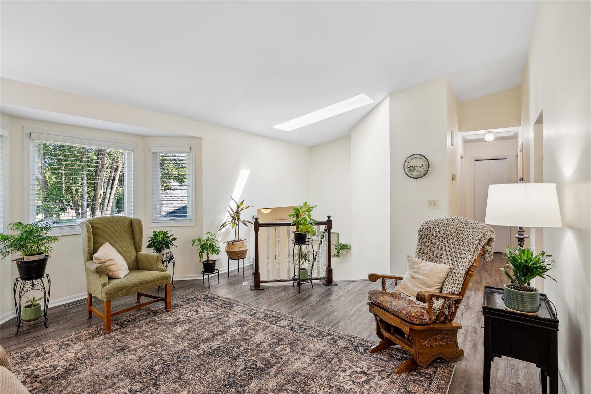 Nice and bright living room with large windows and a skylight.