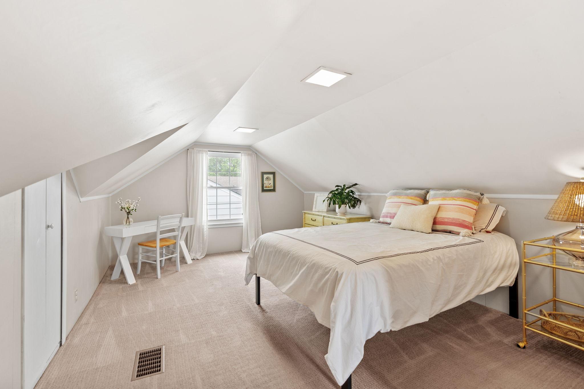 The primary suite is located on the upper-level and includes multiple options for storage including the adorable built-ins.