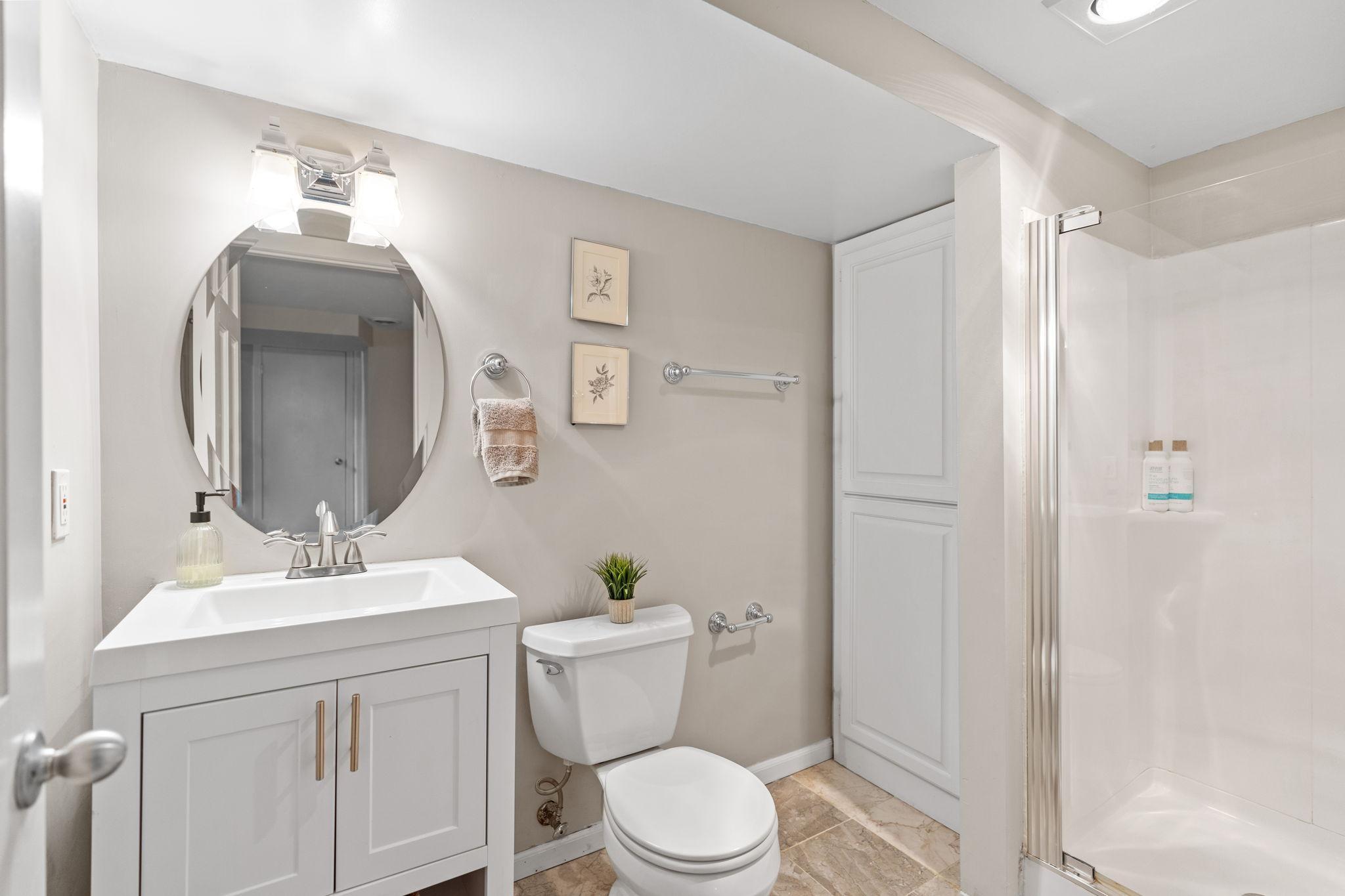 The lower level bathroom includes a walk-in shower and plenty of storage.