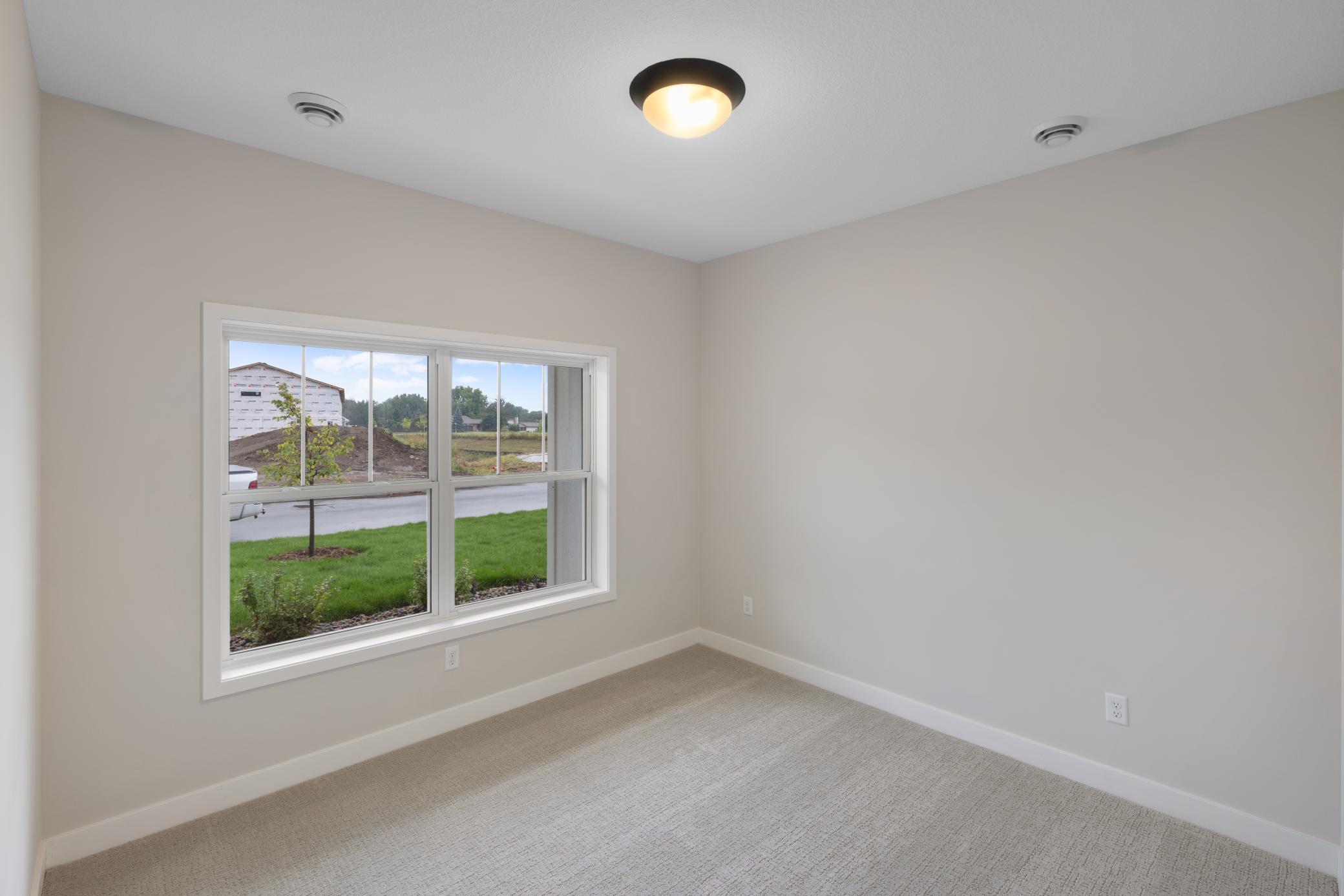 Situated at the front of the home, the second bedroom offers a private and cozy retreat. Measuring 13x11, this room provides ample space for various uses, whether as a guest room, home office, or children's room. *colors and finishes may vary.