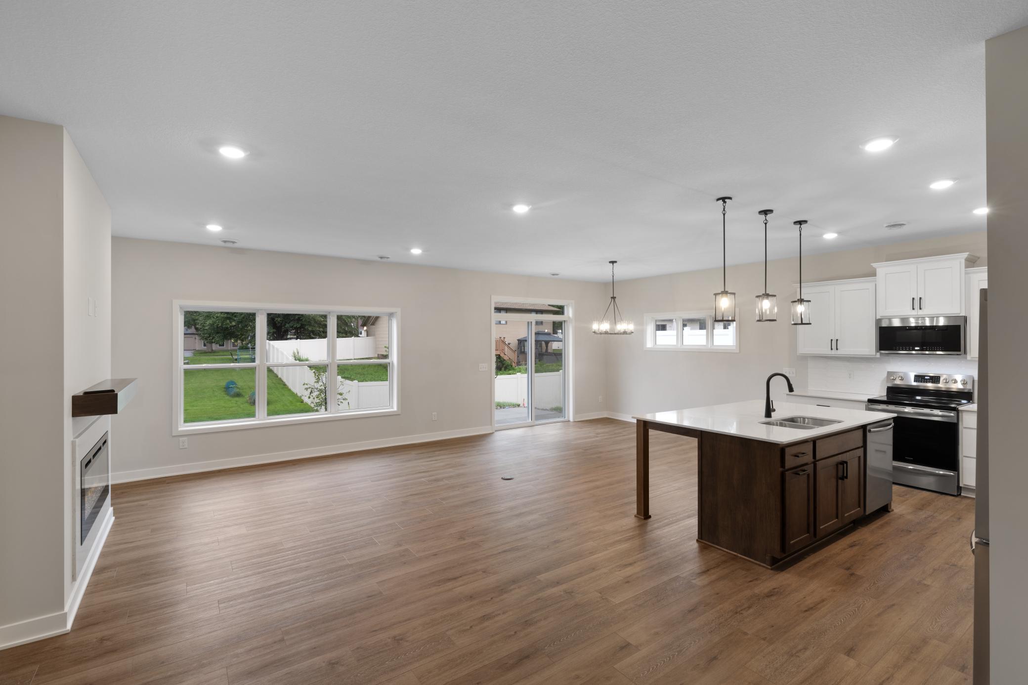 Enjoy a spacious and inviting main floor layout, featuring an open concept design that seamlessly blends living, dining, and kitchen areas. *interior colors and finishes may vary.