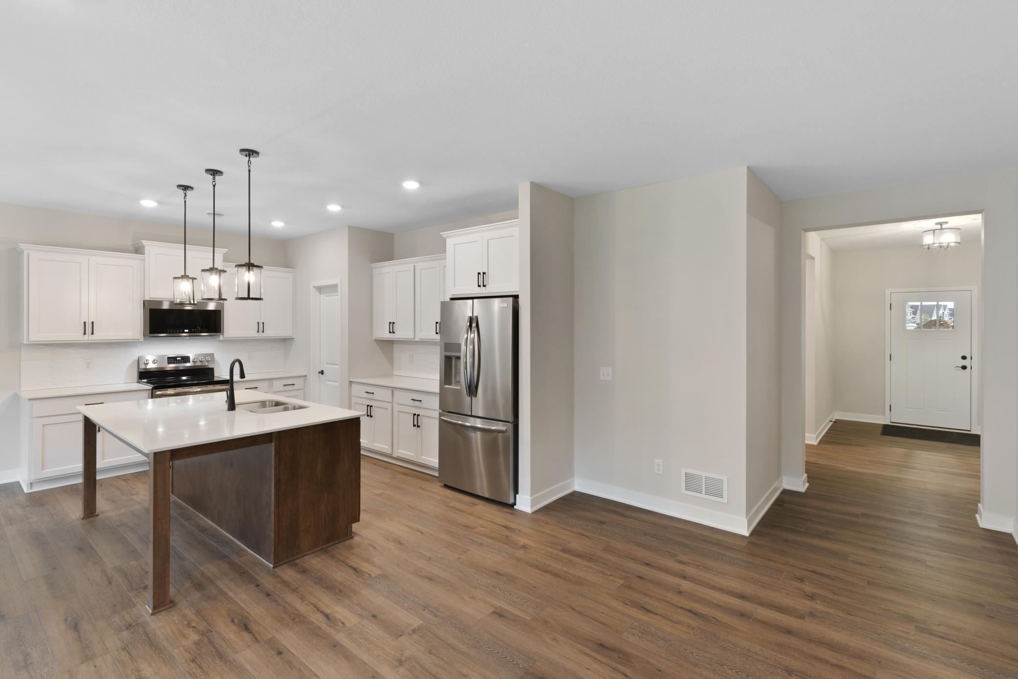 Beautifully designed kitchen featuring an extended island, perfect for meal prep and entertaining. A large corner pantry offers ample storage. *colors/finishes may vary.