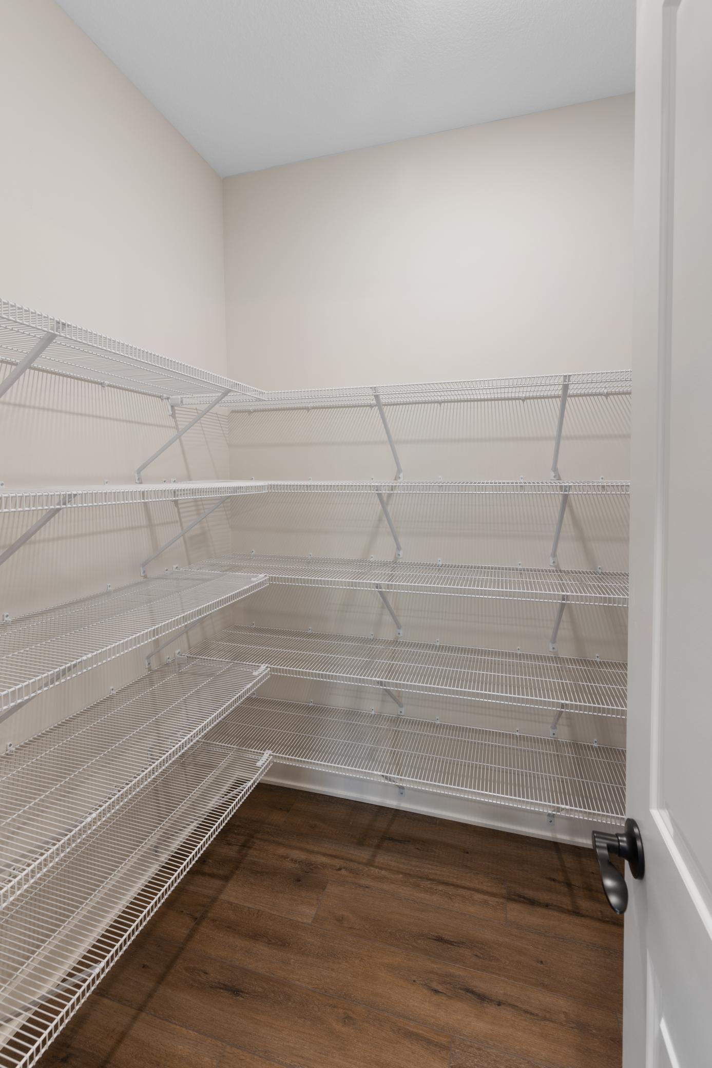 Spacious pantry featuring ample shelving for plenty of storage. *Interior colors and finishes may vary