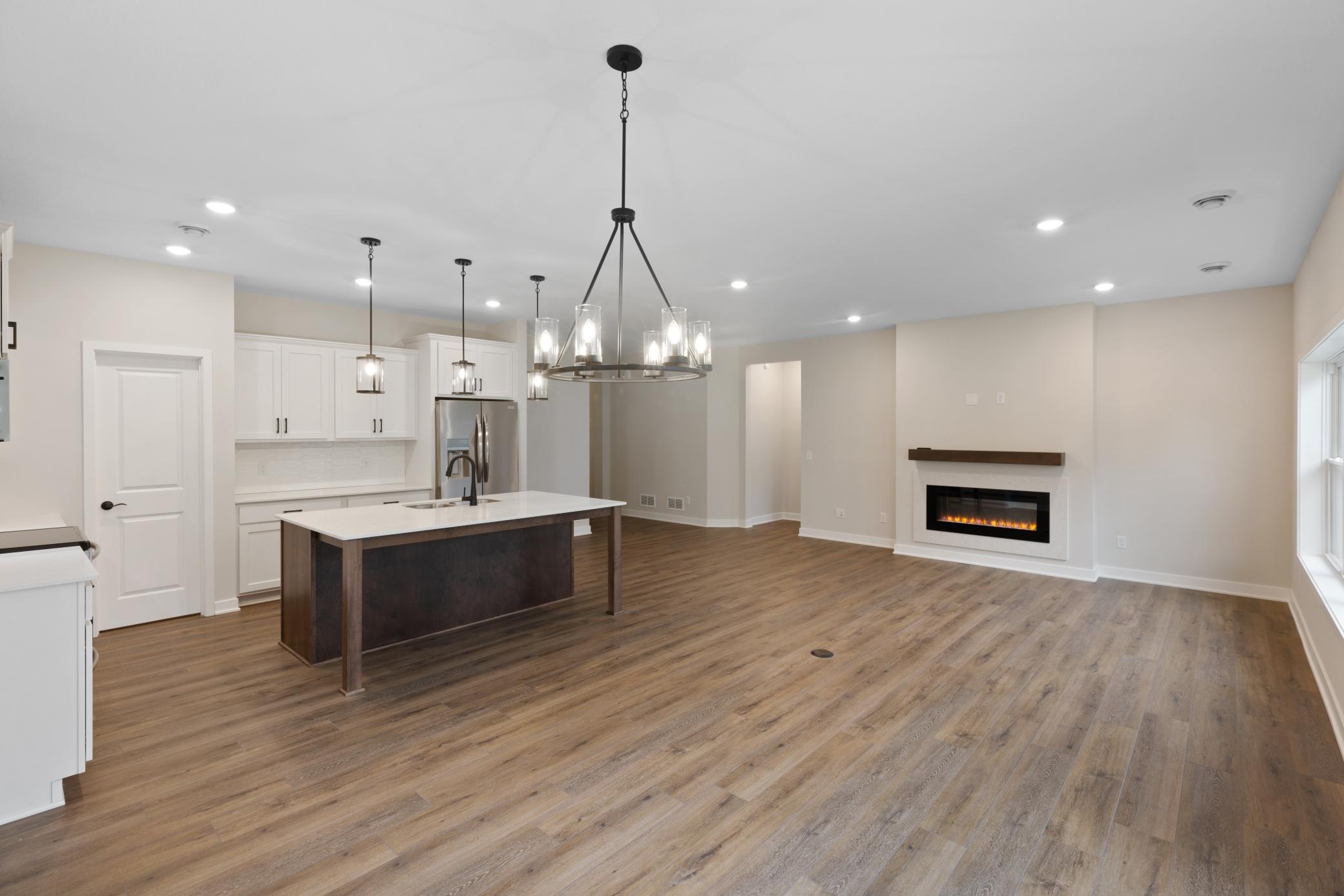 Spacious open-concept living area with abundant natural light and seamless flow to the kitchen and dining areas. Perfect for both relaxing and entertaining, offering flexibility for various furniture configurations. *colors and finishes may vary.