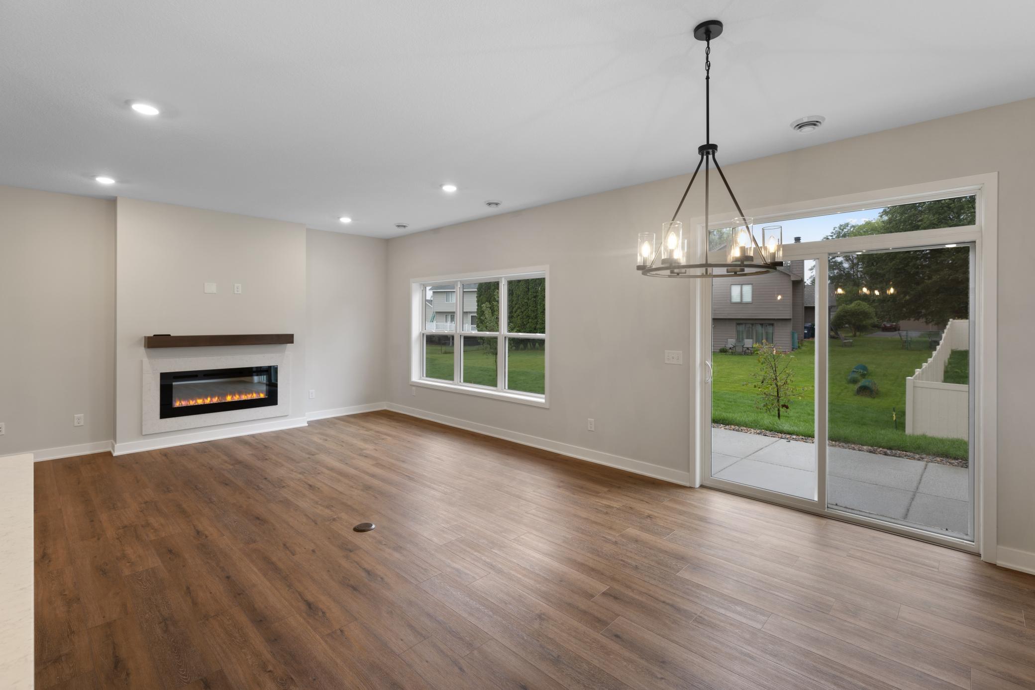 Spacious open-concept living area with abundant natural light and seamless flow to the kitchen and dining areas. Perfect for both relaxing and entertaining, offering flexibility for various furniture configurations. *colors and finishes may vary.