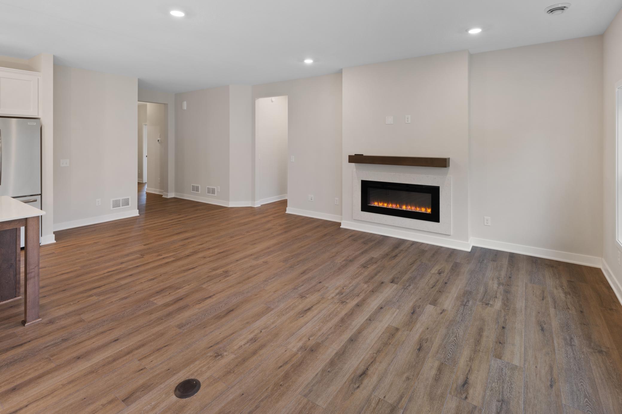 Spacious open-concept living area with abundant natural light and seamless flow to the kitchen and dining areas. Perfect for both relaxing and entertaining, offering flexibility for various furniture configurations. *colors and finishes may vary.