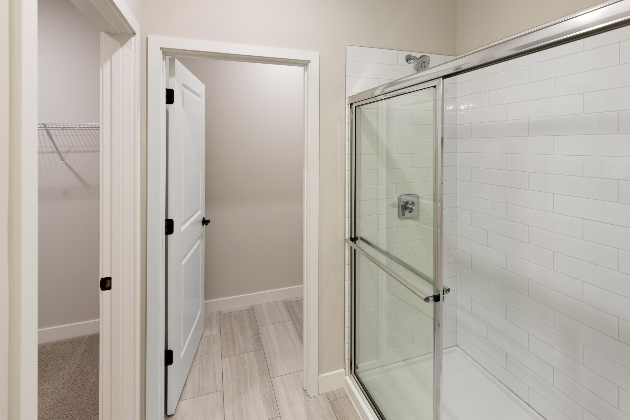 Spacious primary bath features a double vanity for added convenience and a luxurious 5' tiled shower, offering both style and functionality for a relaxing retreat. Perfect for unwinding after a long day. *interior colors/selection may vary.