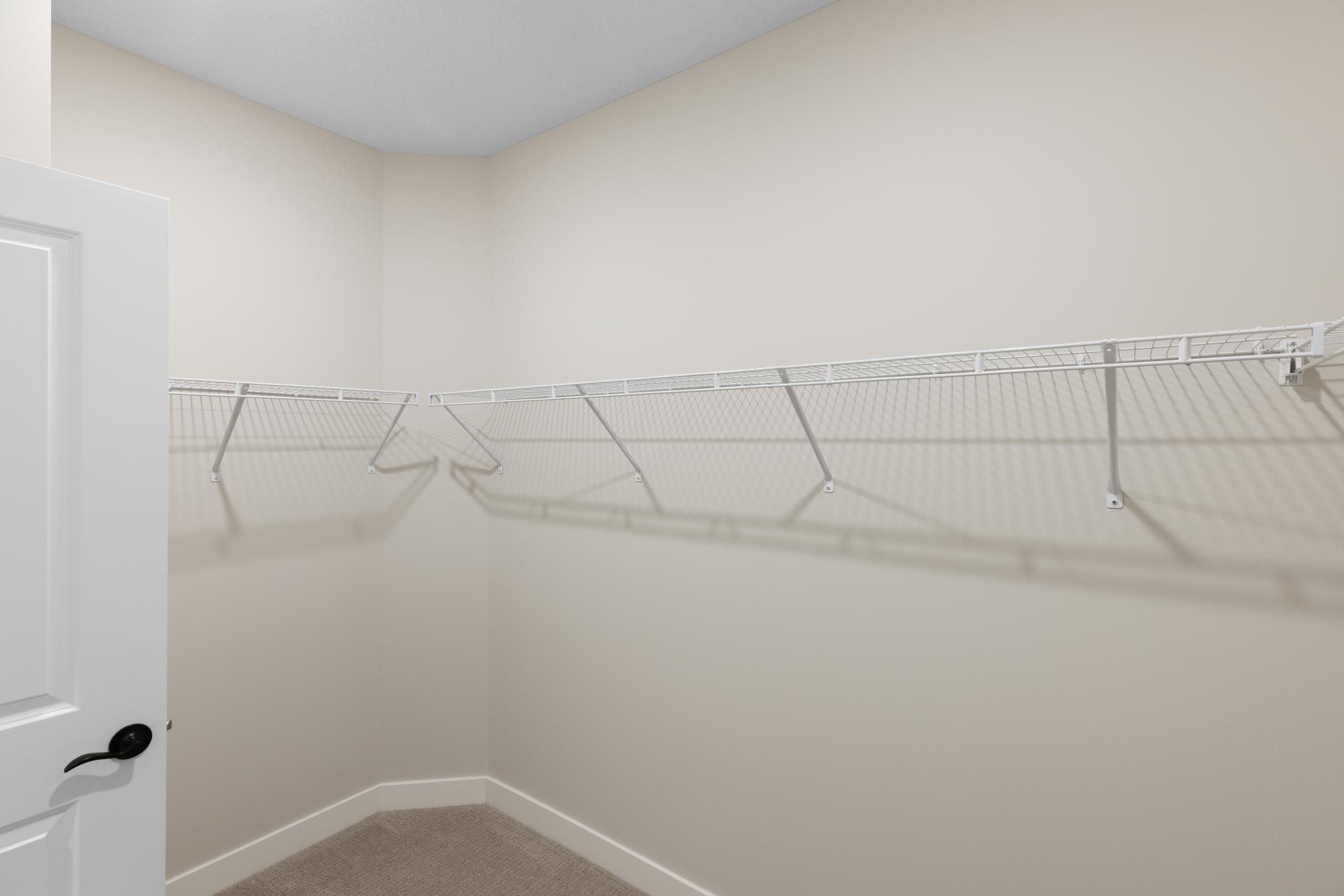 The generous walk-in closet provides ample space for all your storage needs, with plenty of room for organizing clothes, shoes, and accessories, creating a tidy and efficient dressing area. *interior colors/selection may vary.