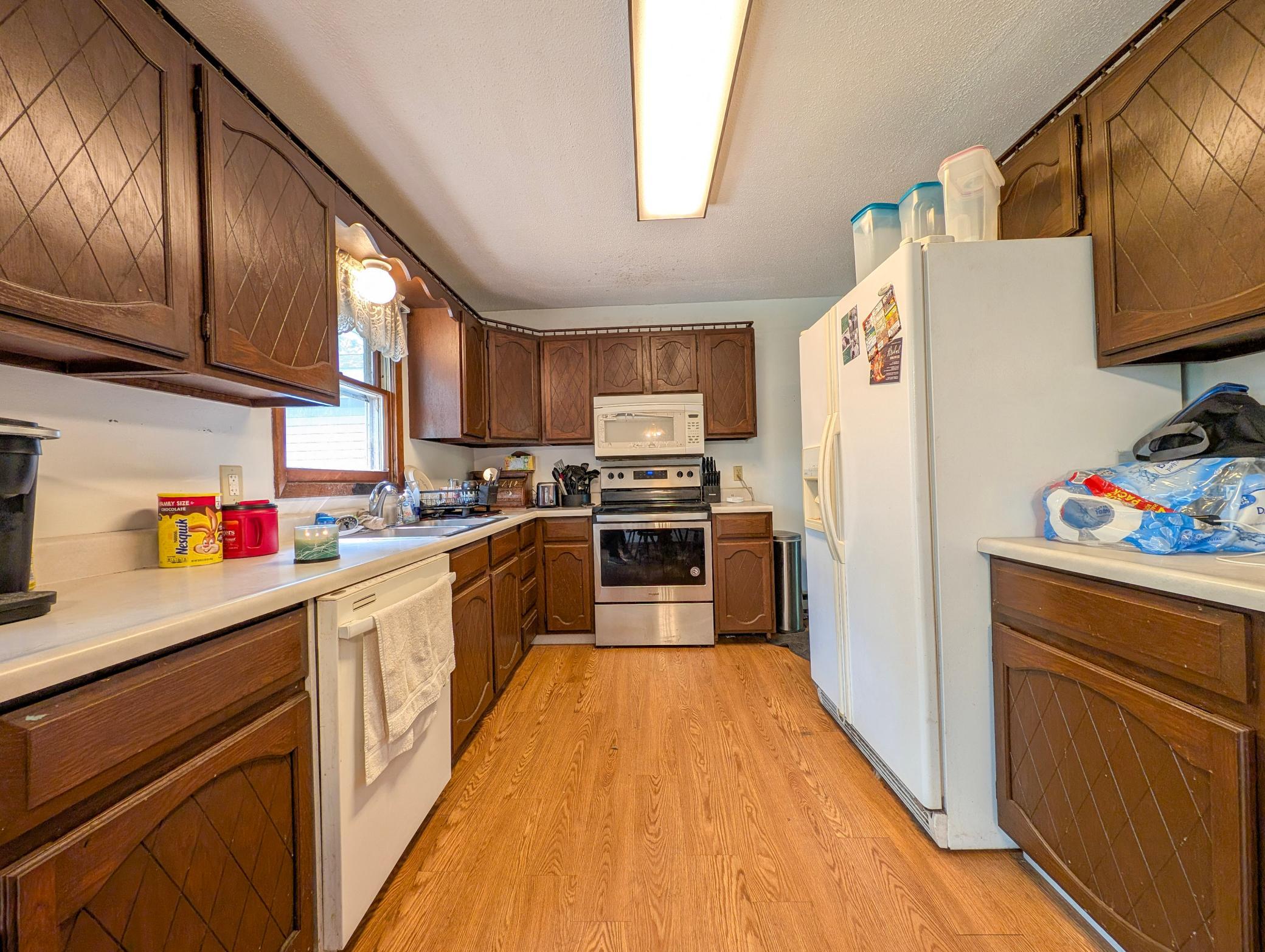 kitchen with plenty of counter space, classic cabinetry, and natural light pouring in.