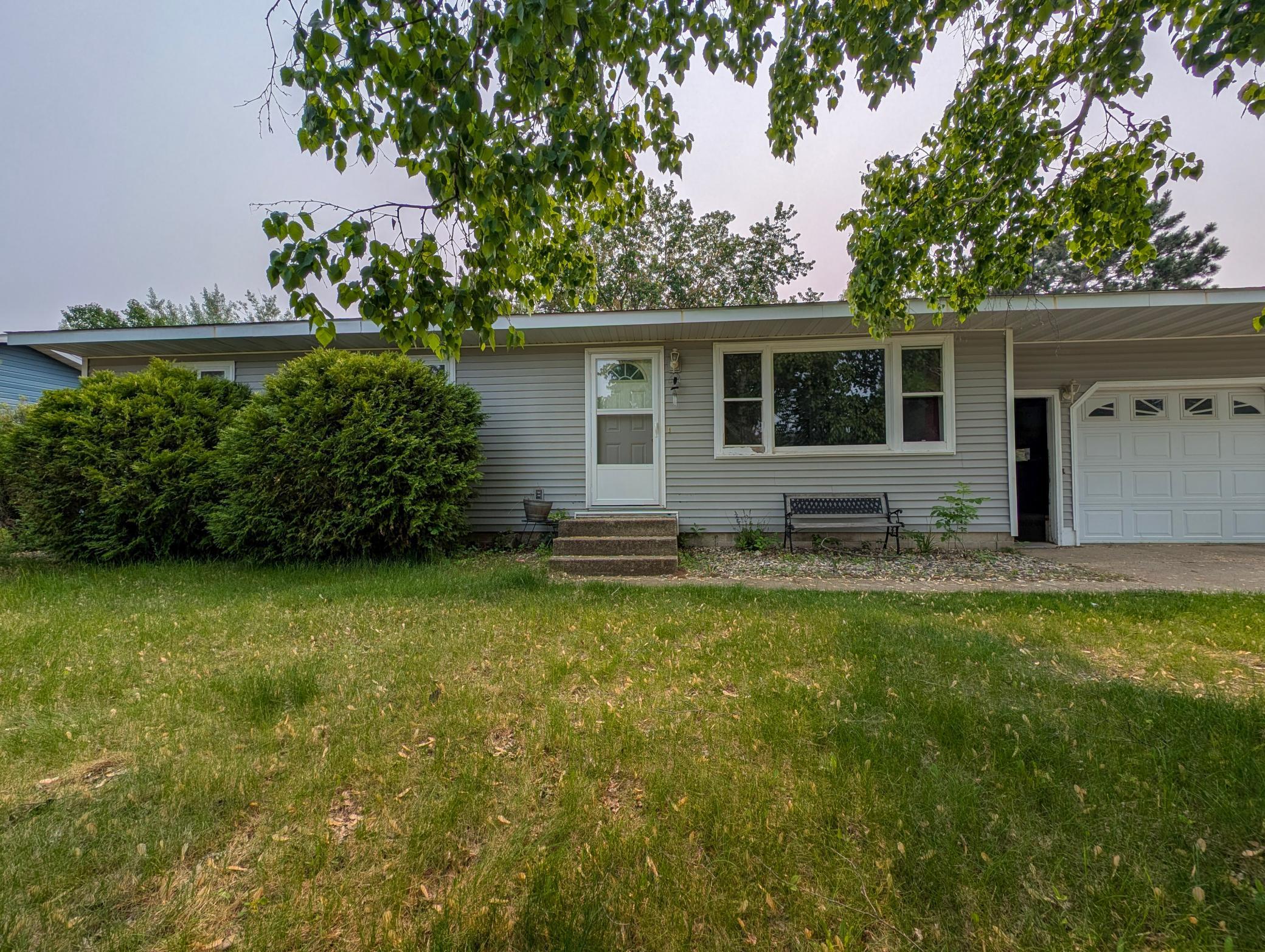 Charming curb appeal with mature trees, clean siding, and a cozy front entrance—this home has been well cared for and it shows.