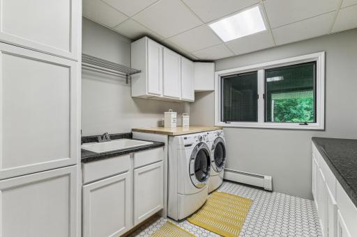 Laundry room with lots of counterspace and cabinetry