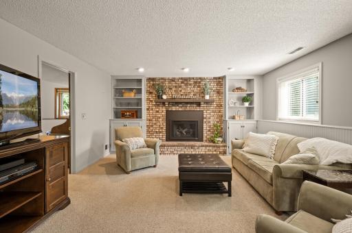 Spacious family room in the 3rd lower-level with look-out window for natural light. Built-ins for game nights and a cozy fireplace. Newer windows and freshly cleaned carpet!!
