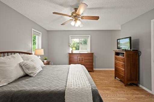 Upper level private ensuite primary bedroom with large walk-in closet and updated bathroom.