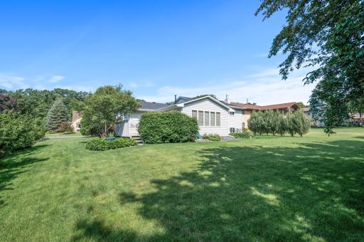 View from the backyard. This corner lot provides such great space to play sports all summer! Yard games, get ready!