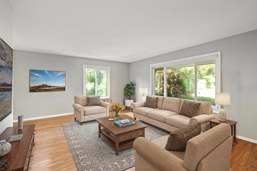 Large front living room with newer windows! Look at the size of the windows! All custom window treatments included. Virtually staged.