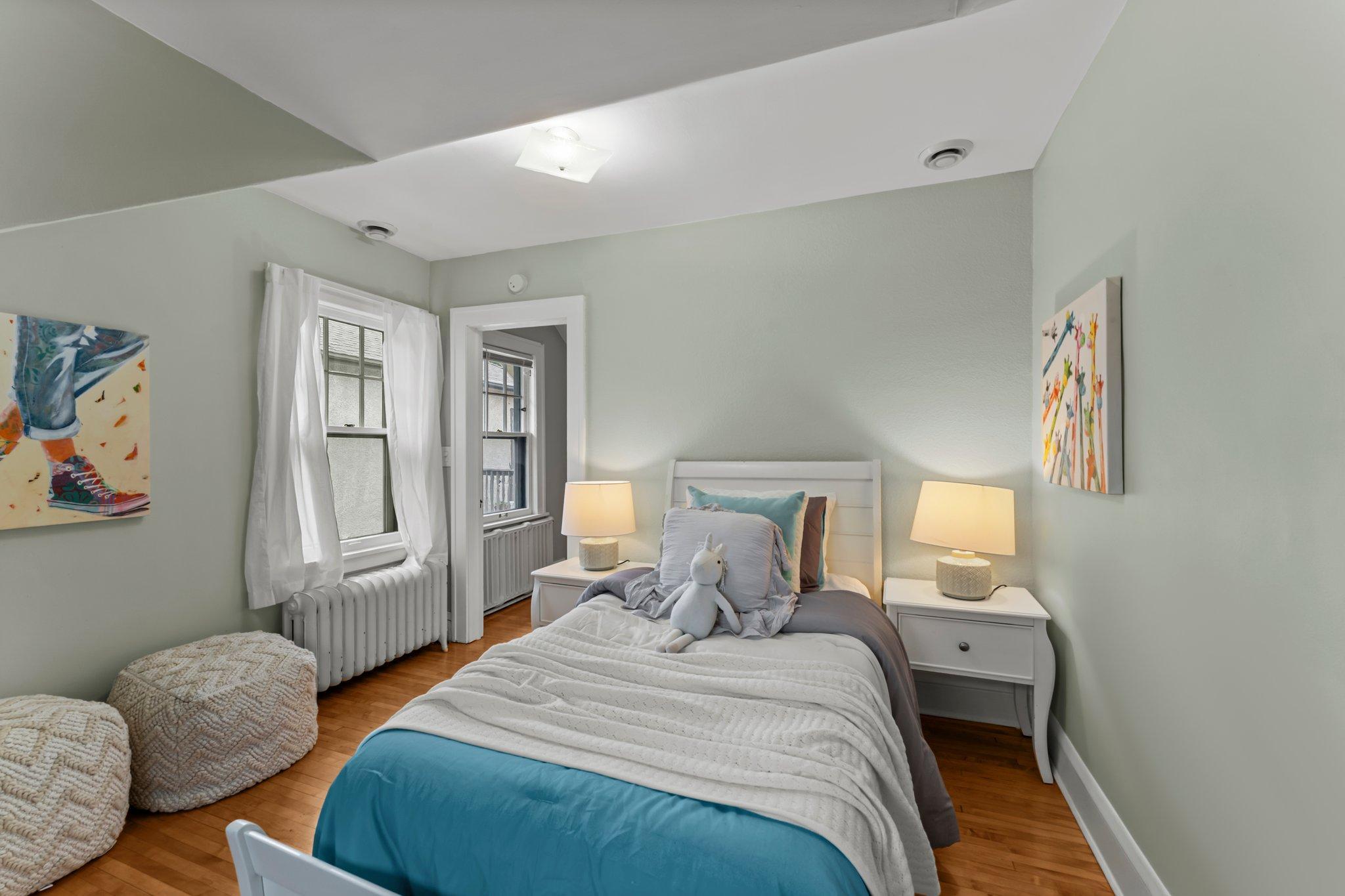 Upstairs, the second bedroom offers views of the fully landscaped front yard, along with generous closet space and natural light.