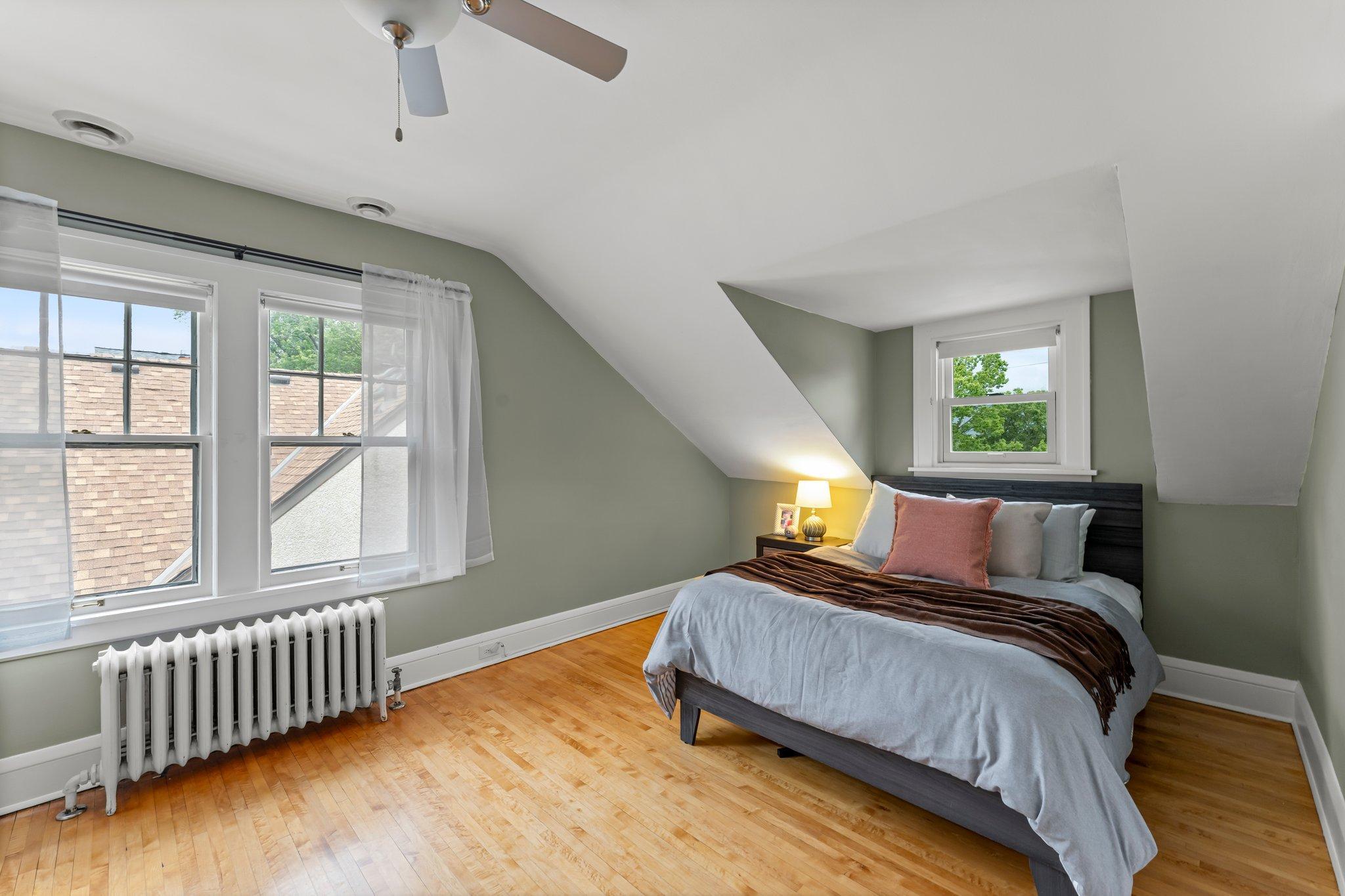 Across the hall, the third bedroom features dual closets, a ceiling fan, and more scenic views.