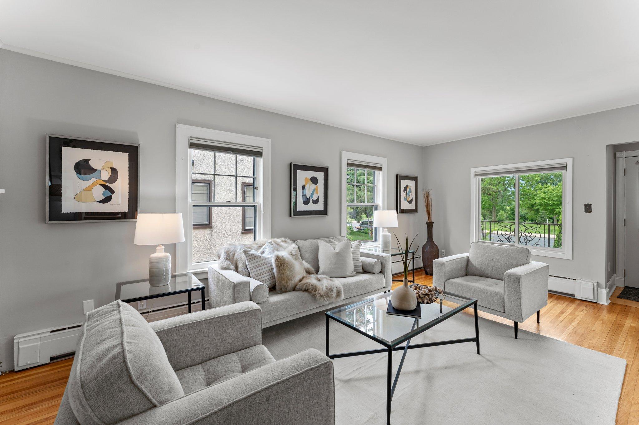 Large windows provide an abundance of natural light and create a warm, welcoming space.