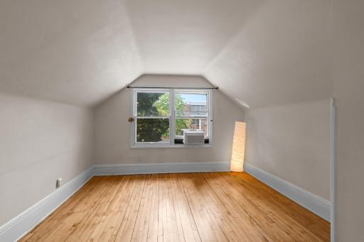 Spacious upper-level living room featuring hardwood floors and abundant natural light.