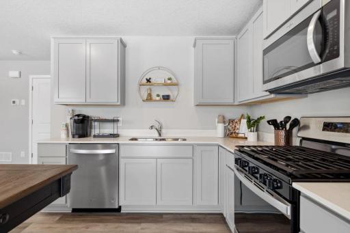 Stainless steel appliances and quartz countertops. Photo is of model home. Colors and options may vary. Ask Sales Agent for details.