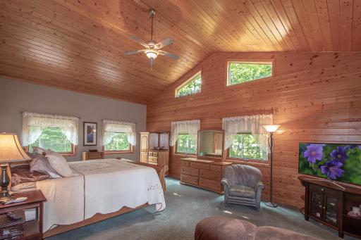 Natural light and vaulted ceiling adds to sizable bedroom