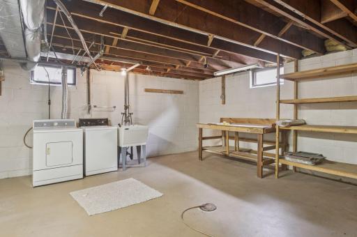 Laundry room with work bench and built-in shelves