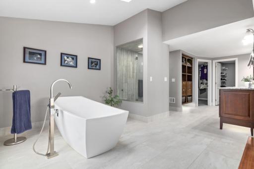 The bathroom also features a walk-in shower, double vanities with elegant finishes, and fantastic lighting and large closets beyond. This is more than a bedroomâitâs your private lakefro