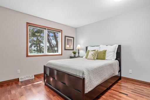 One of 4 spacious bedroom located upstairs. Beautiful flooring and stunning lake views.