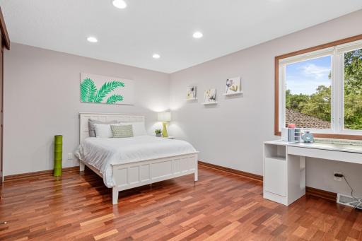 One of 4 spacious bedrooms upstairs offering abundant space and bright light streaming in. This room also has its own sink- perfect for brushing teeth and washing your hands.